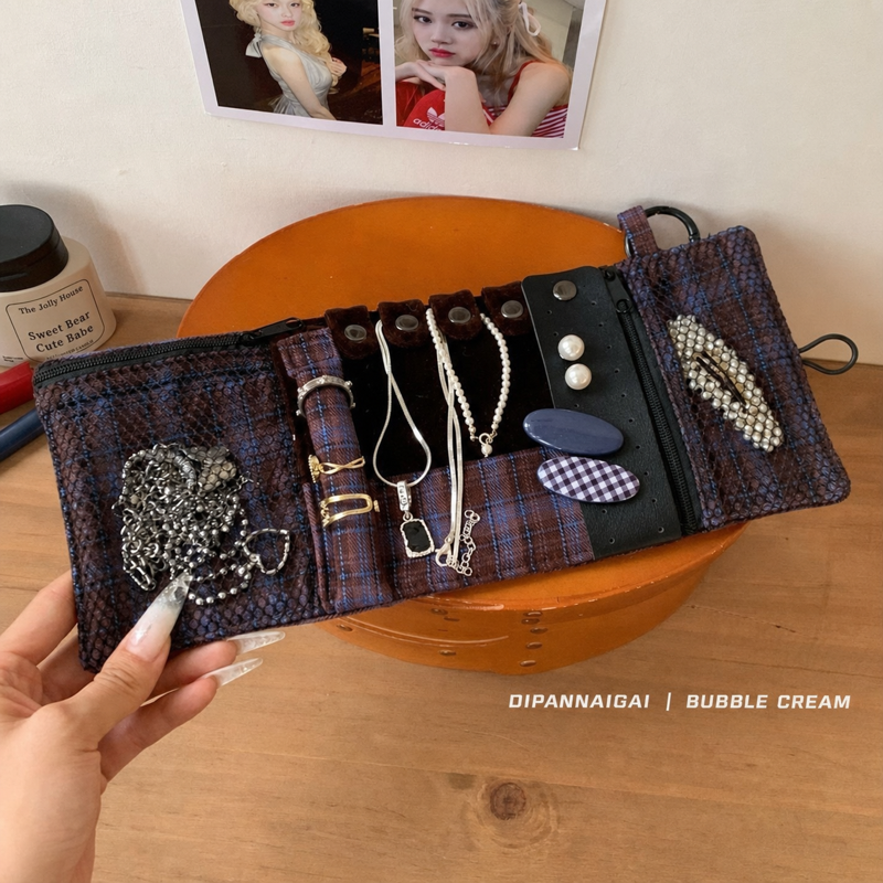 Interior view with necklaces, rings, earrings, and zip pockets