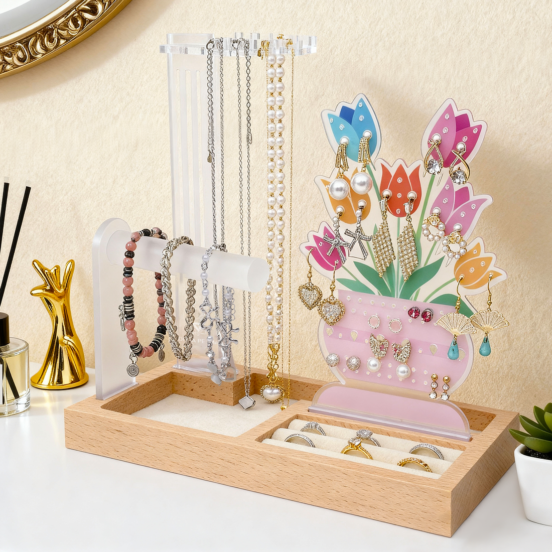 Oversized statement earrings and shoulder duster styles displayed on a decorative Orna Pegma organizer stand