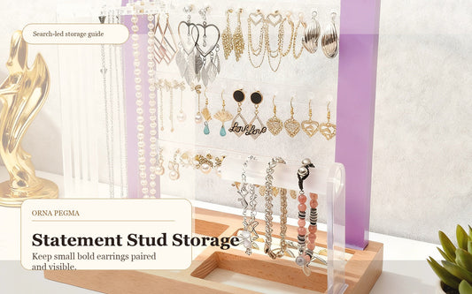 Statement stud earrings and small hoops organized on an Orna Pegma earring display stand