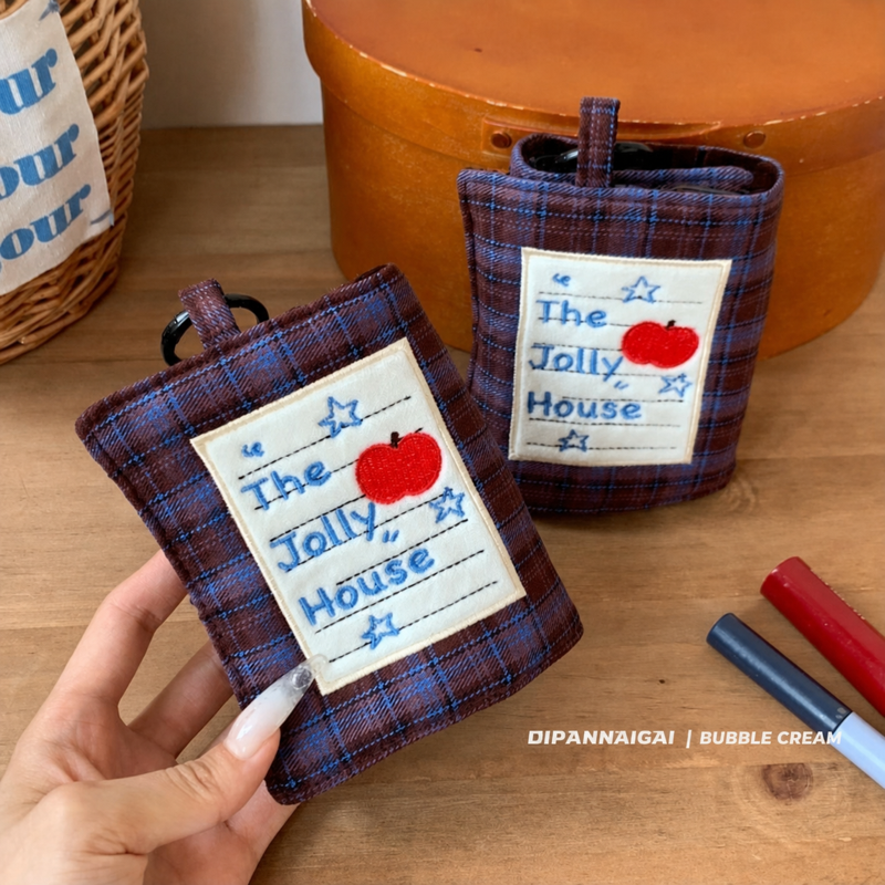 Plaid travel jewelry organizer shown closed