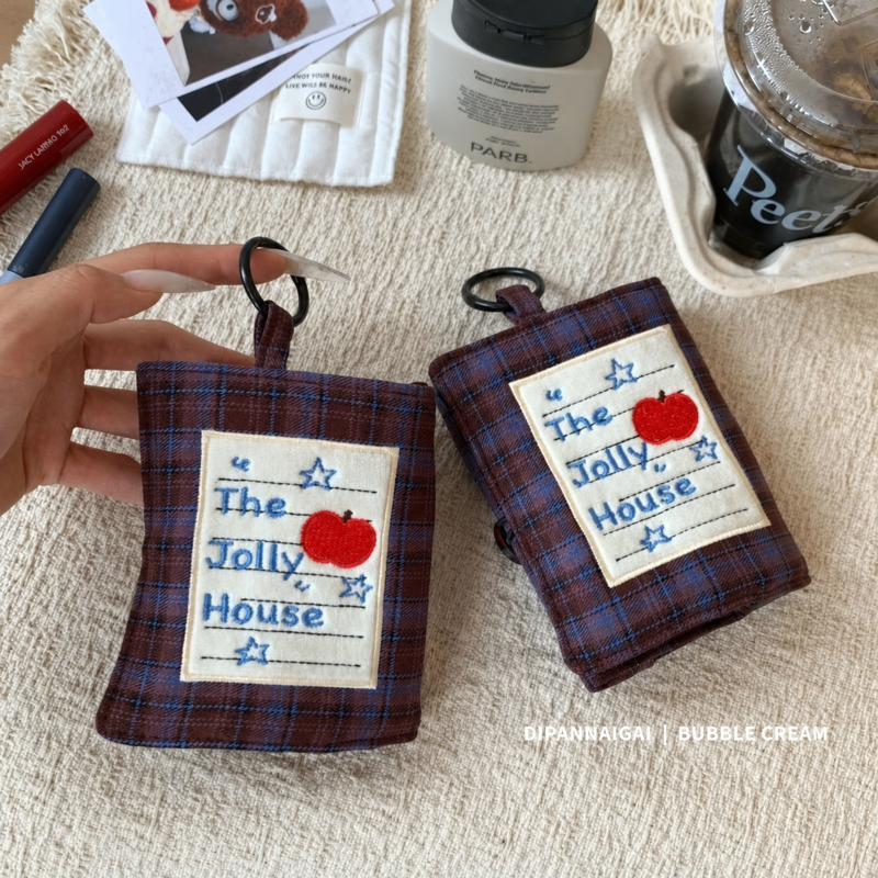 Plaid case with apple patch shown upright