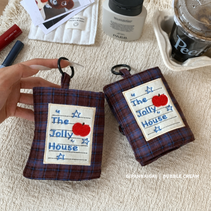 Plaid case with apple patch shown upright