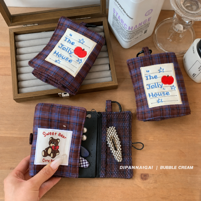 Plaid jewelry case shown folded and open