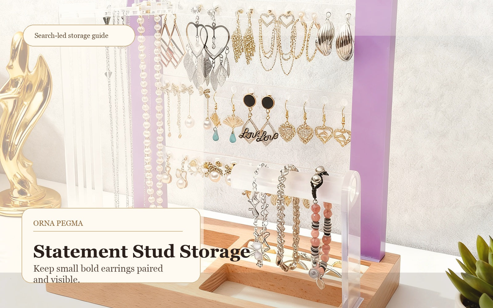 Statement stud earrings and small hoops organized on an Orna Pegma earring display stand